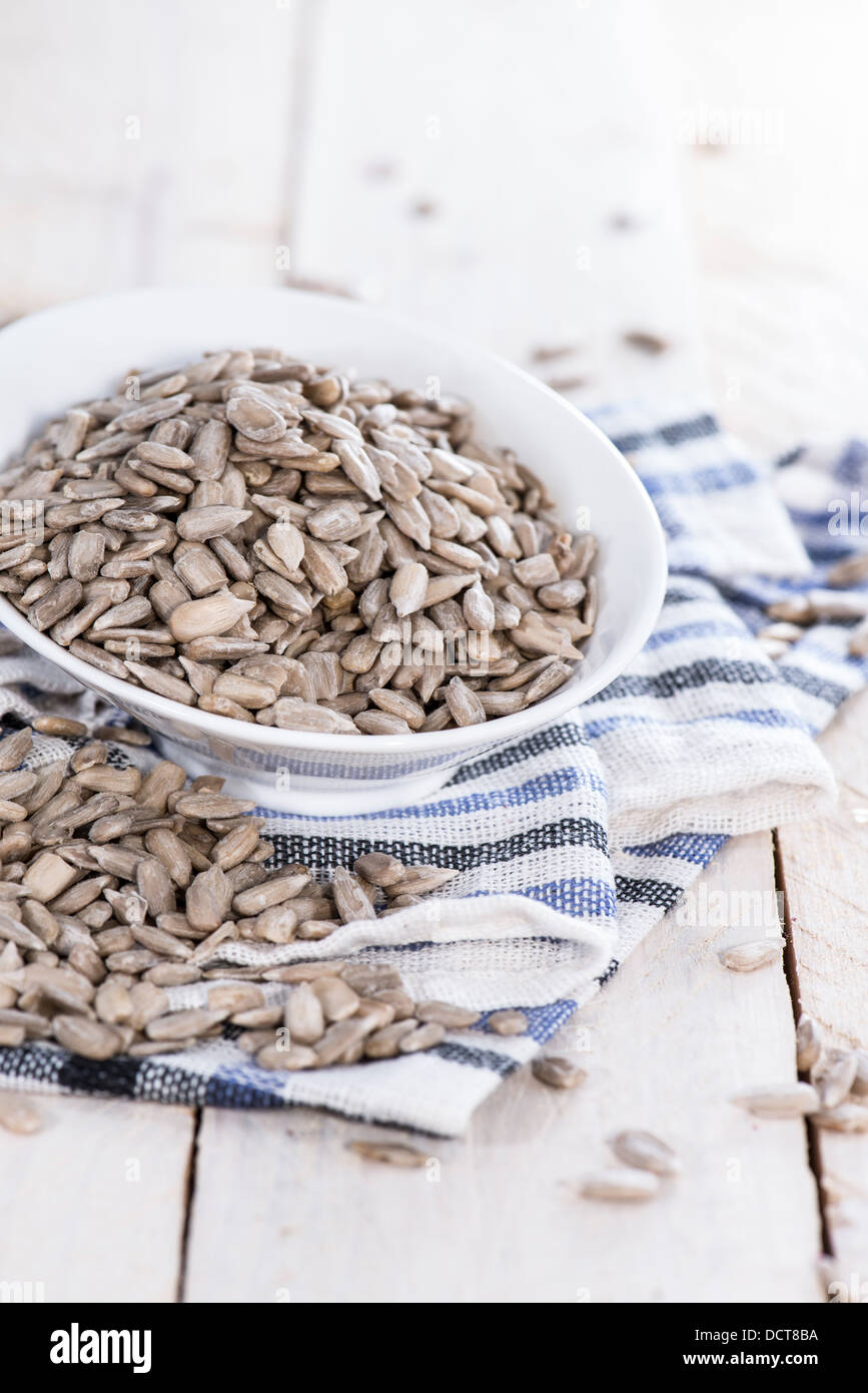 Portion of Sunflower Seeds on wooden background Stock Photo