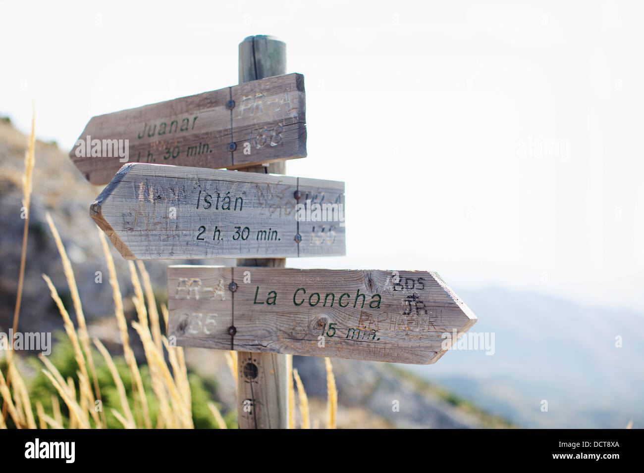 Wooden Destination And Distance Signs; Marbella, Malaga, Andalusia, Spain Stock Photo