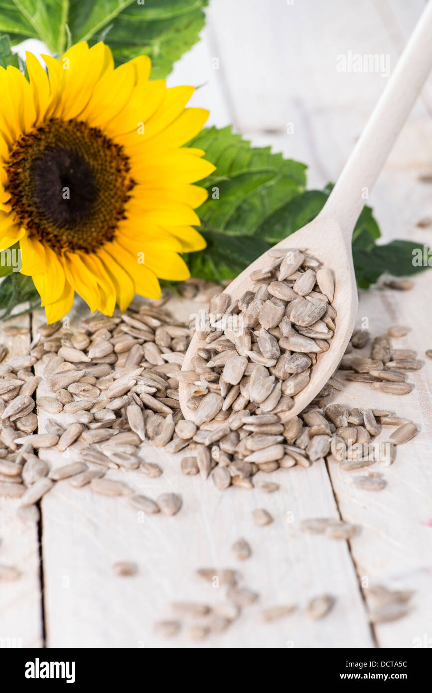 Portion of Sunflower Seeds on wooden background Stock Photo