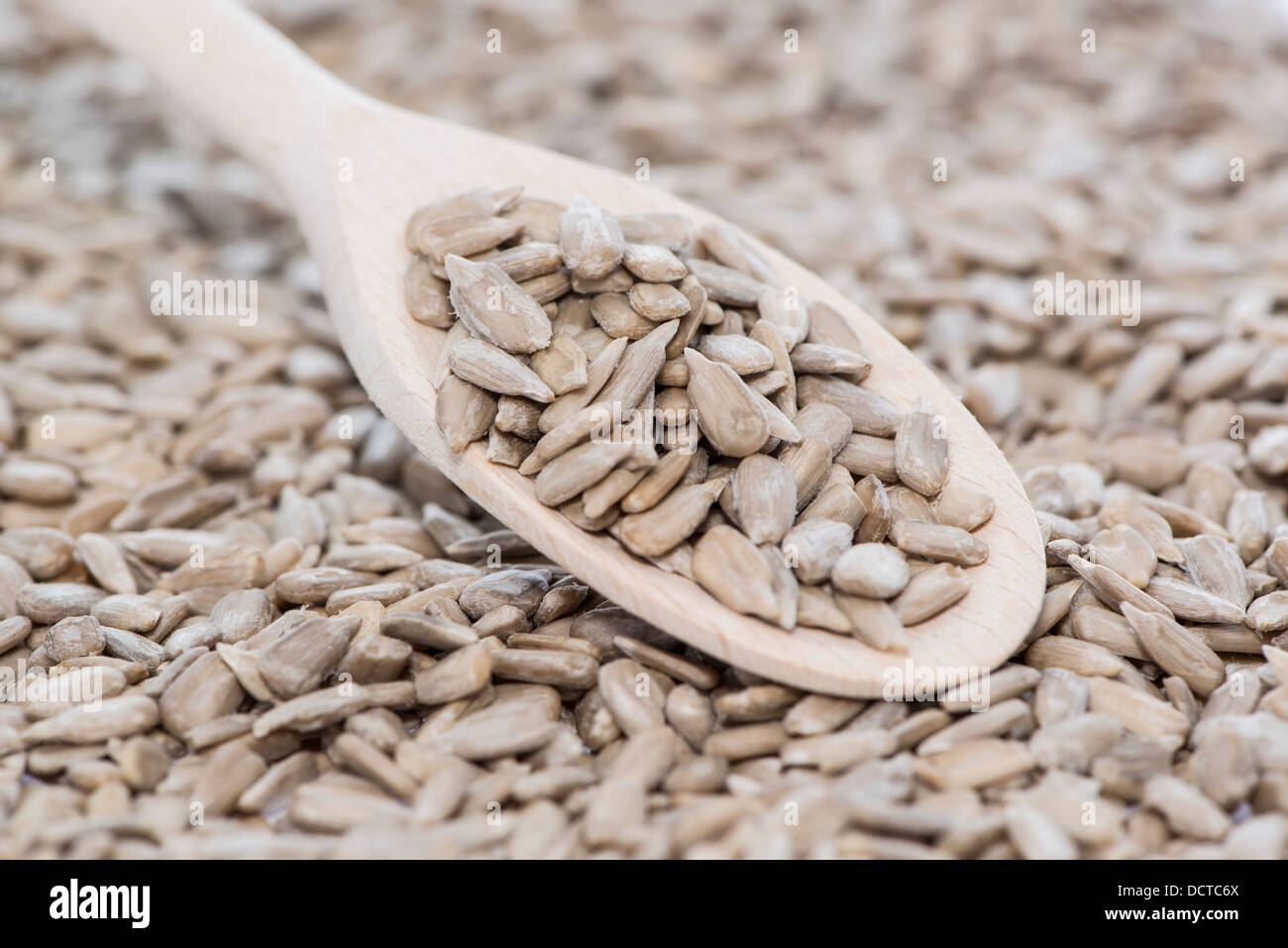 Sunflower Seeds with wooden Spoon (macro shot) Stock Photo