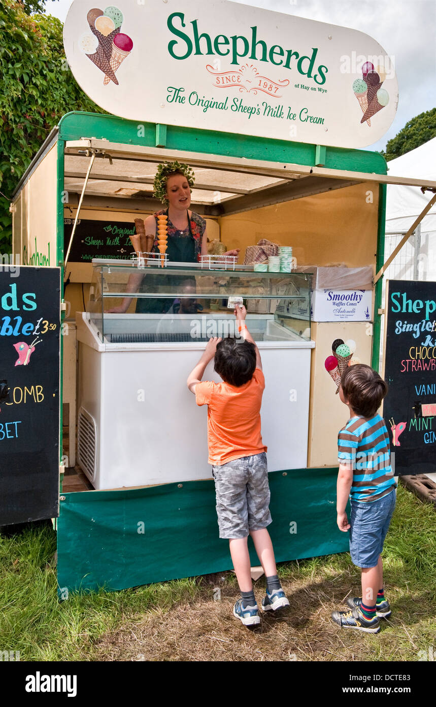 Children buying sheep's milk ice cream from the Shepherds stand at the annual Green Man music festival, Glanusk, Crickhowell, Wales, UK Stock Photo