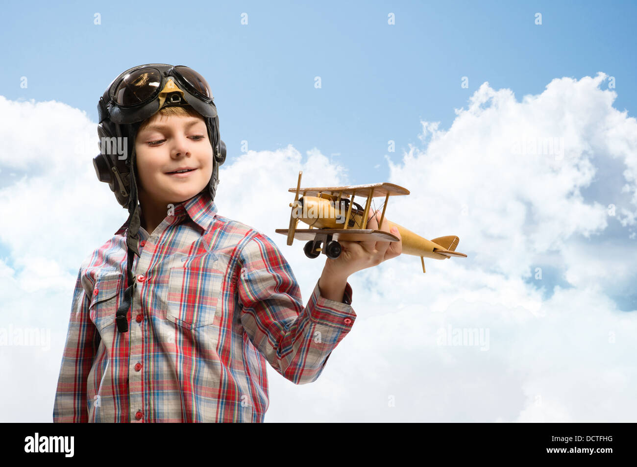 Boy in helmet pilot playing with a toy airplane Stock Photo - Alamy