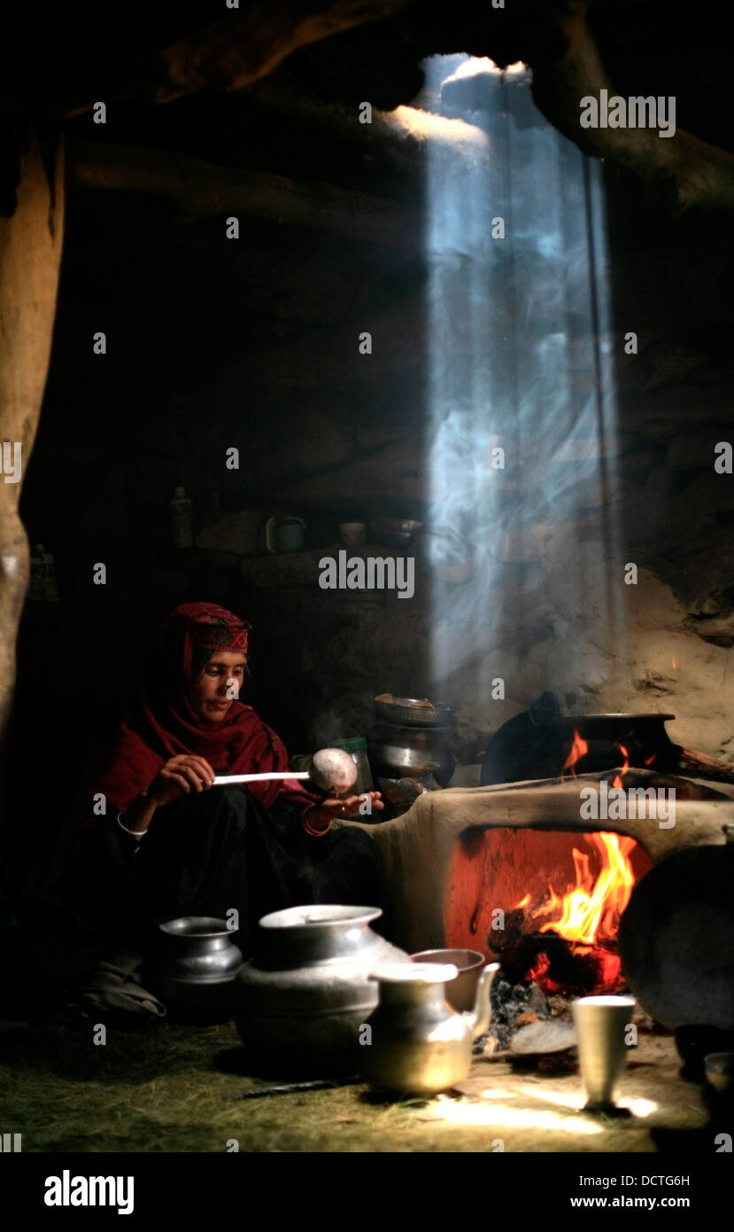 Woman Cooking By The Fire; Kolahoi, Kashmir, India Stock Photo