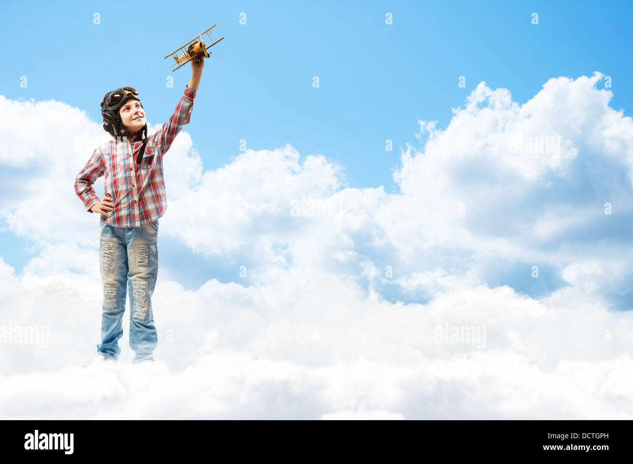 Boy in helmet pilot playing with a toy airplane Stock Photo - Alamy