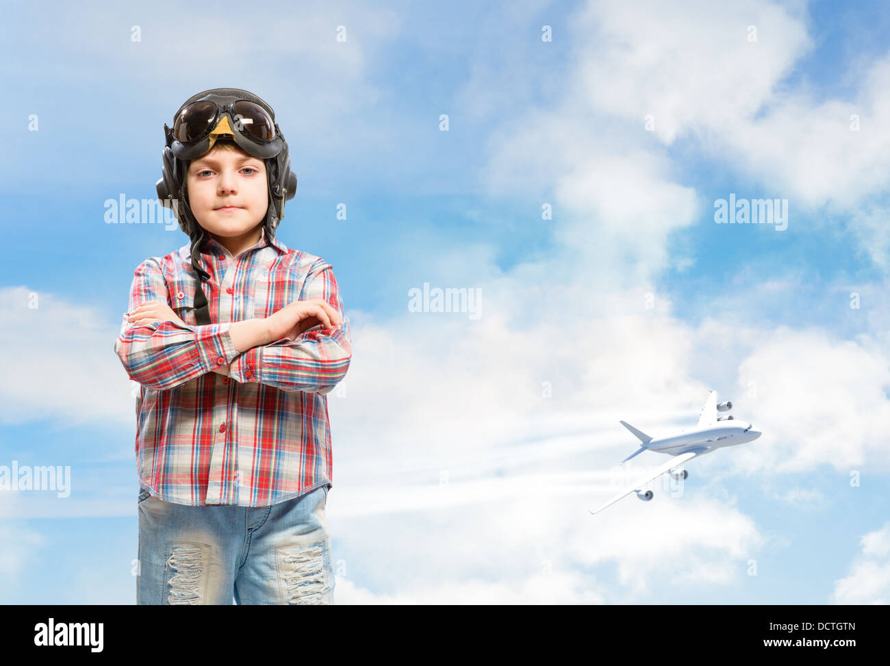 Boy in helmet pilot dreaming of becoming a pilot Stock Photo