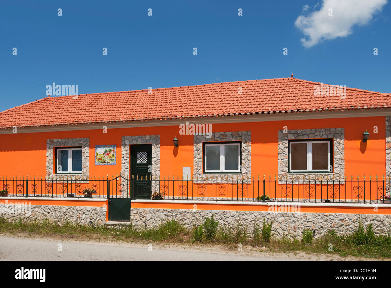 House Painted Orange; Leiria, Estremadura And Ribatejo, Portugal Stock Photo