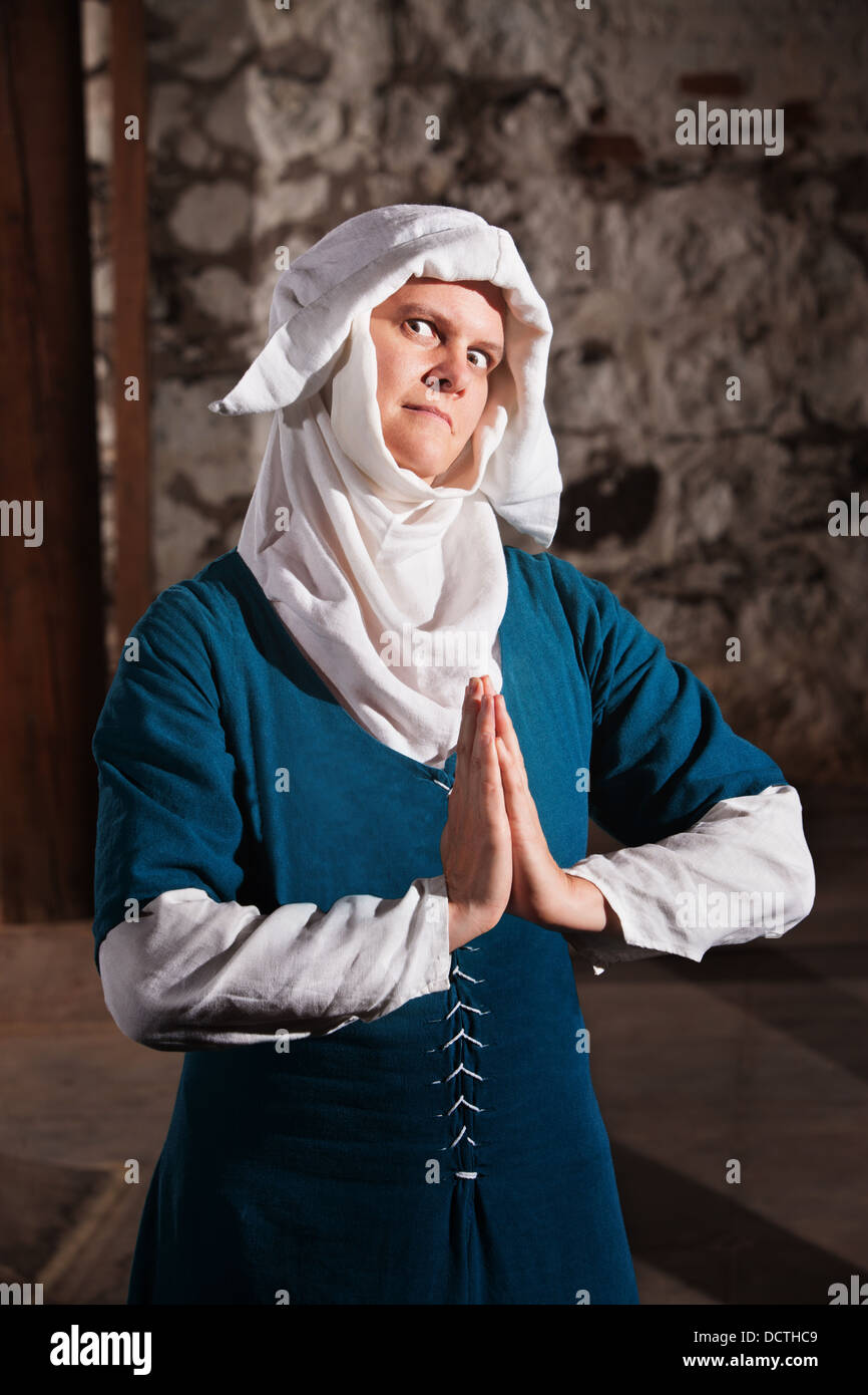 Sinister Nun in Prayer Stock Photo