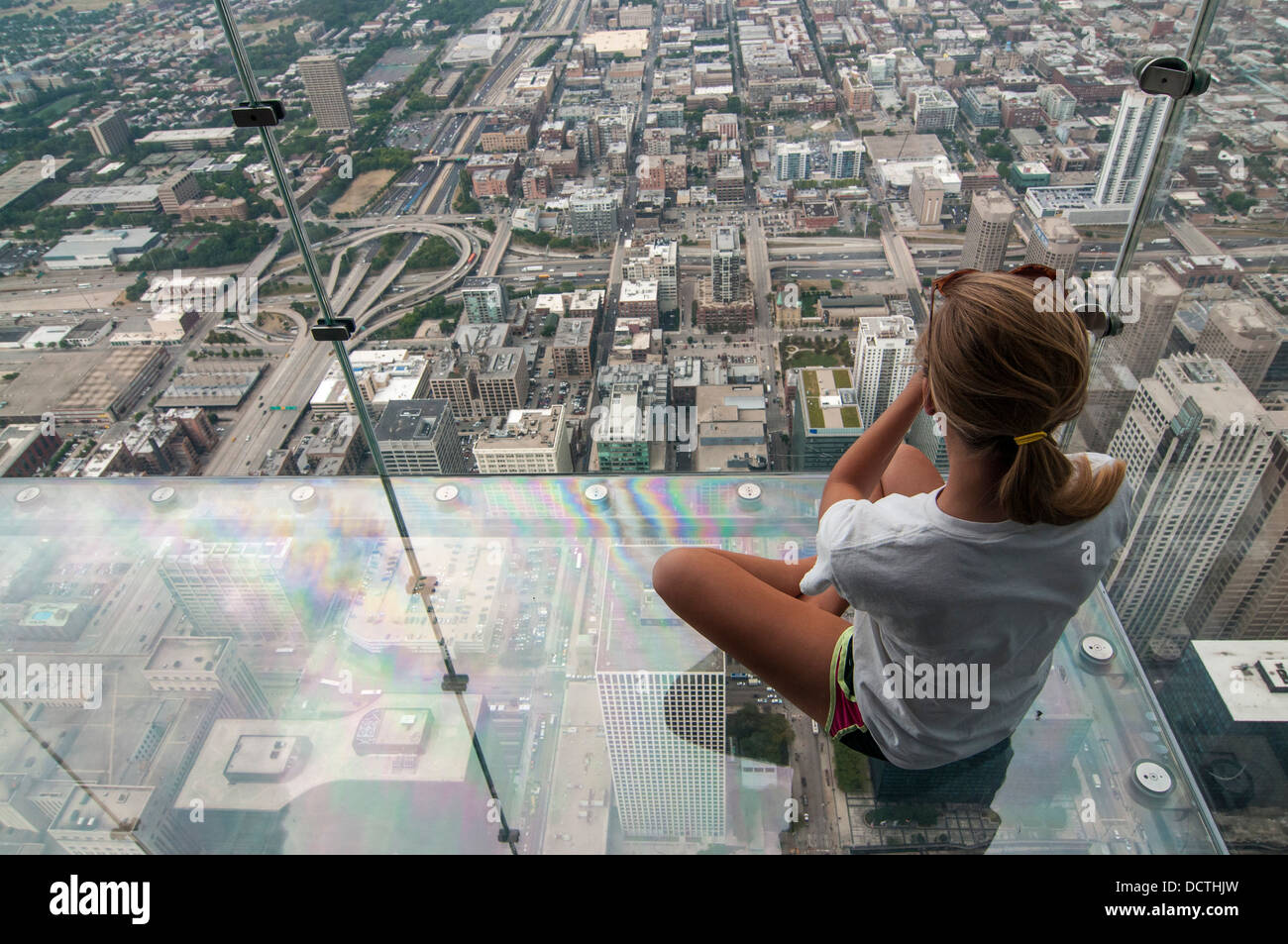 Female tourist in the SkyDeck at the Sears (now Willis) Tower, Sky Deck observation floor, Chicago, Illinois, USA Stock Photo