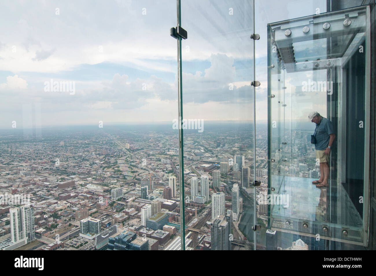 Male tourist in the SkyDeck at the Sears (now Willis) Tower, Sky Deck observation floor, Chicago, Illinois, USA Stock Photo