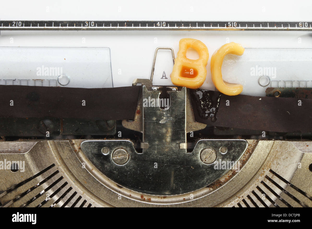 Closeup of typewriter, letter A typed, B and C made up of alphabet spaghetti Stock Photo