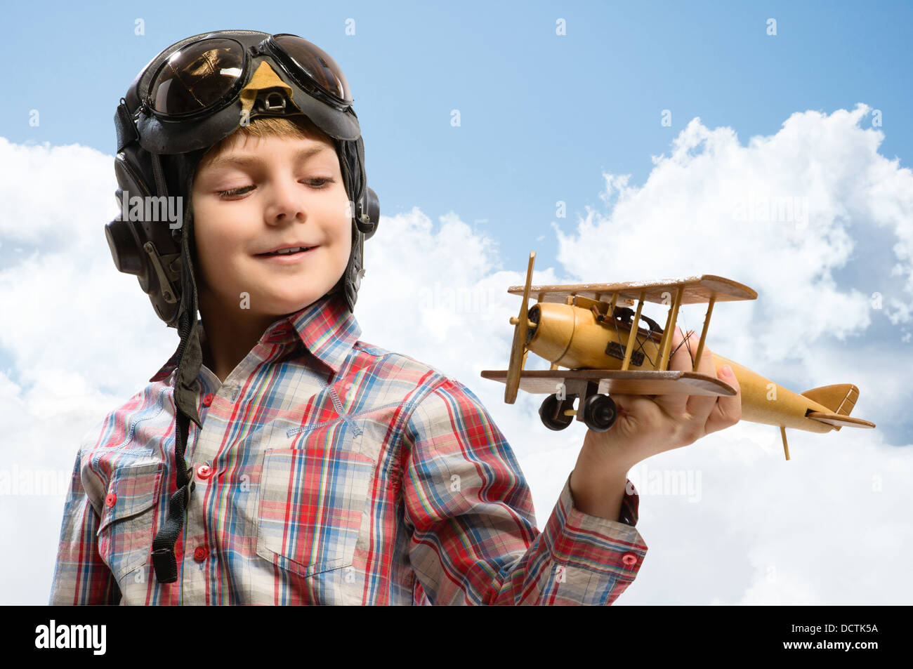 Boy in helmet pilot playing with a toy airplane Stock Photo - Alamy
