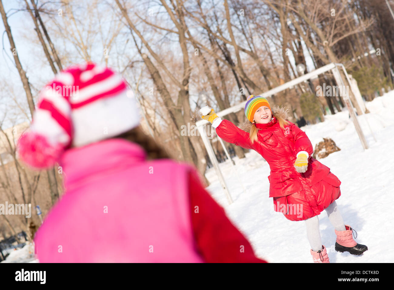 Children in Winter Park playing snowballs Stock Photo - Alamy