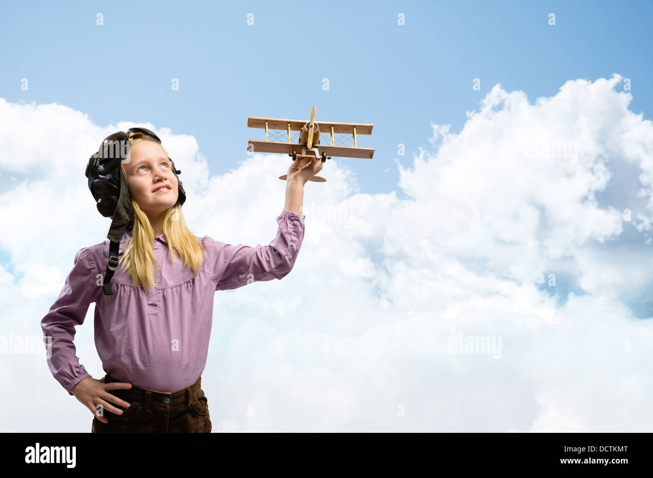 girl in helmet pilot playing with a toy airplane Stock Photo - Alamy