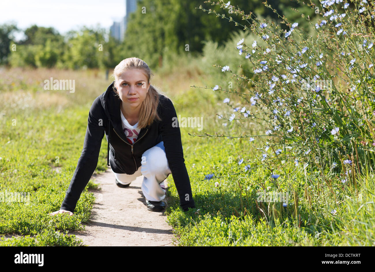 Young woman doing push ups in the park Stock Photo - Alamy