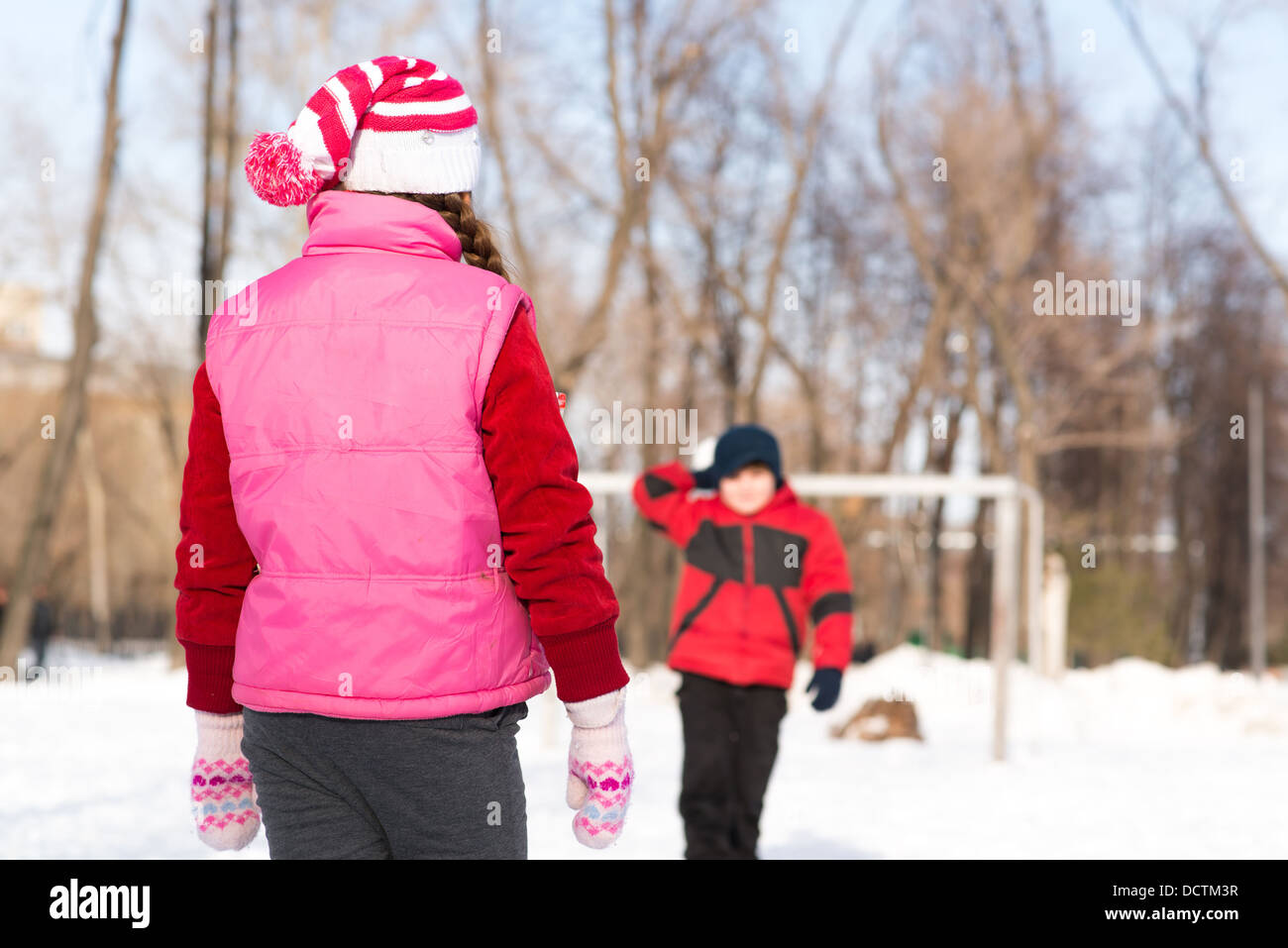 Children in Winter Park playing snowballs Stock Photo - Alamy