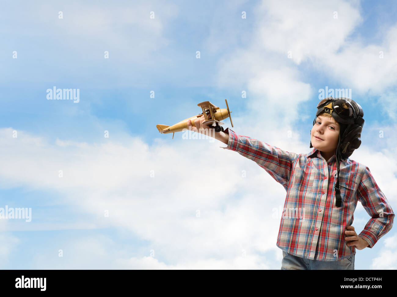 Boy in helmet pilot playing with a toy airplane Stock Photo - Alamy