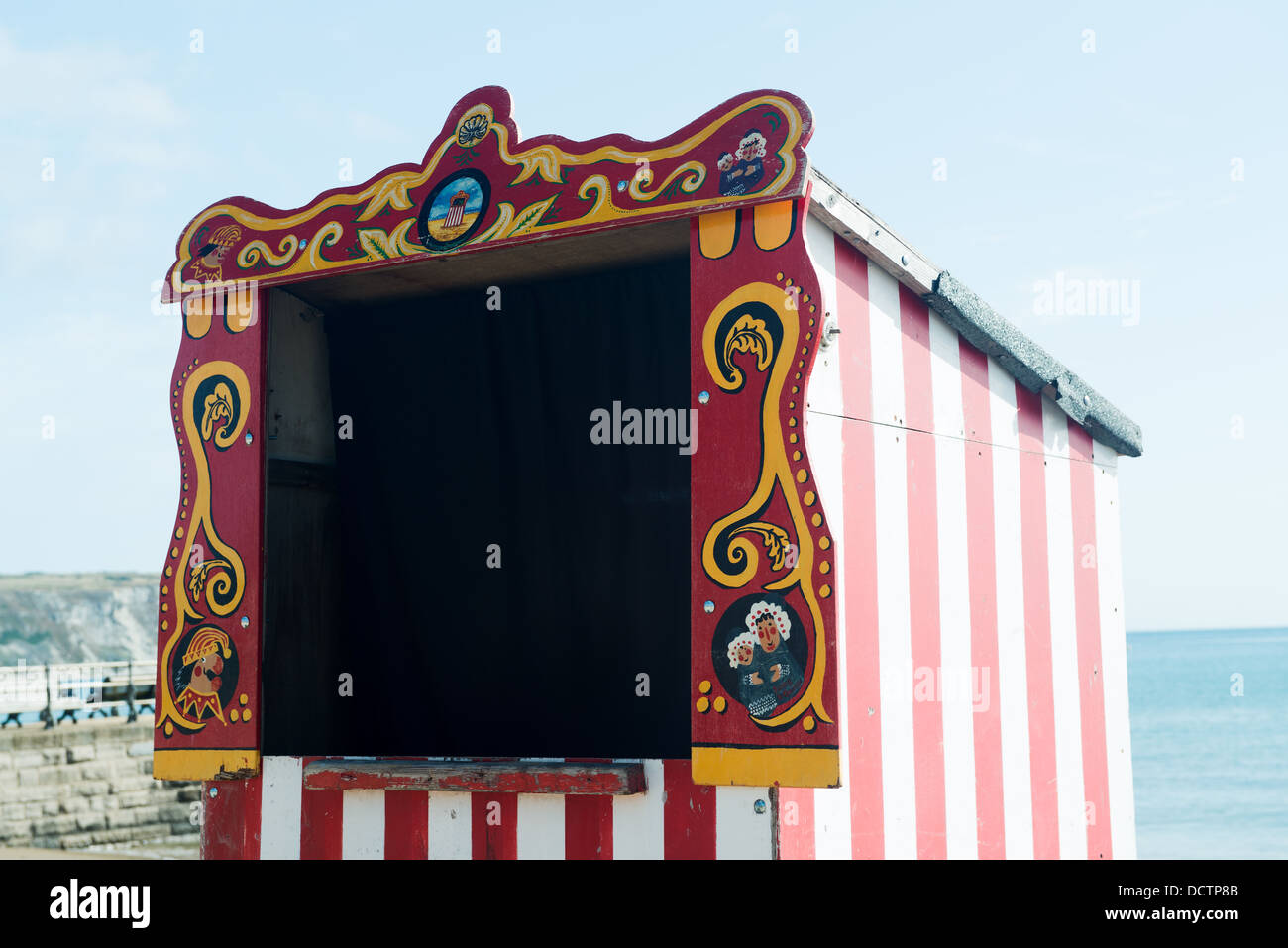 Red and White striped Punch and Judy booth ready for next show on the beach at Swanage Stock Photo