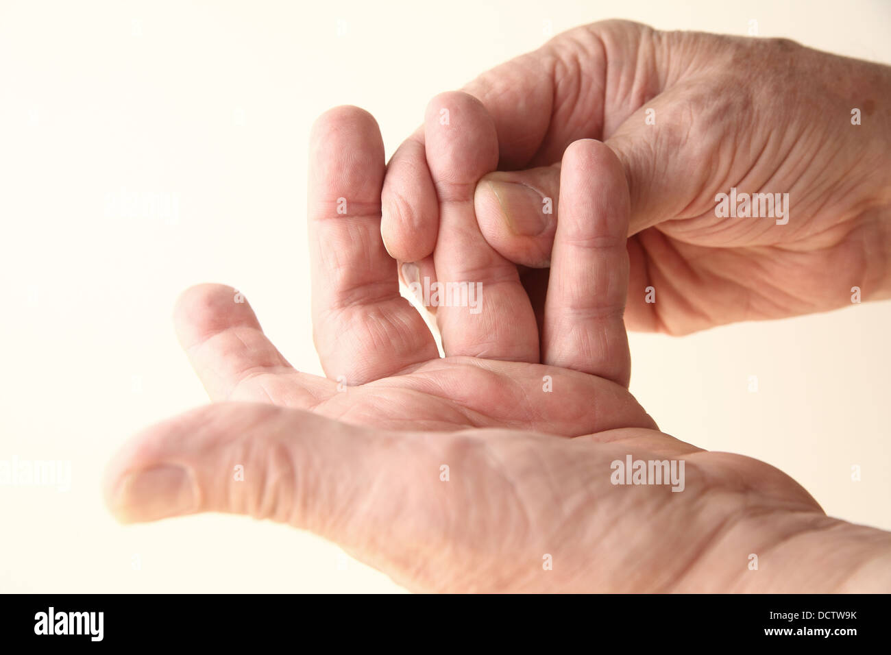 senior man with stiffness or numbness in his finger Stock Photo