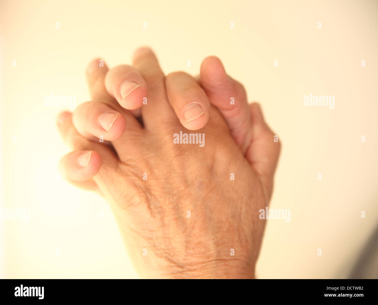 older man's clasped hands either in prayer, thoughtfulness or meditation Stock Photo