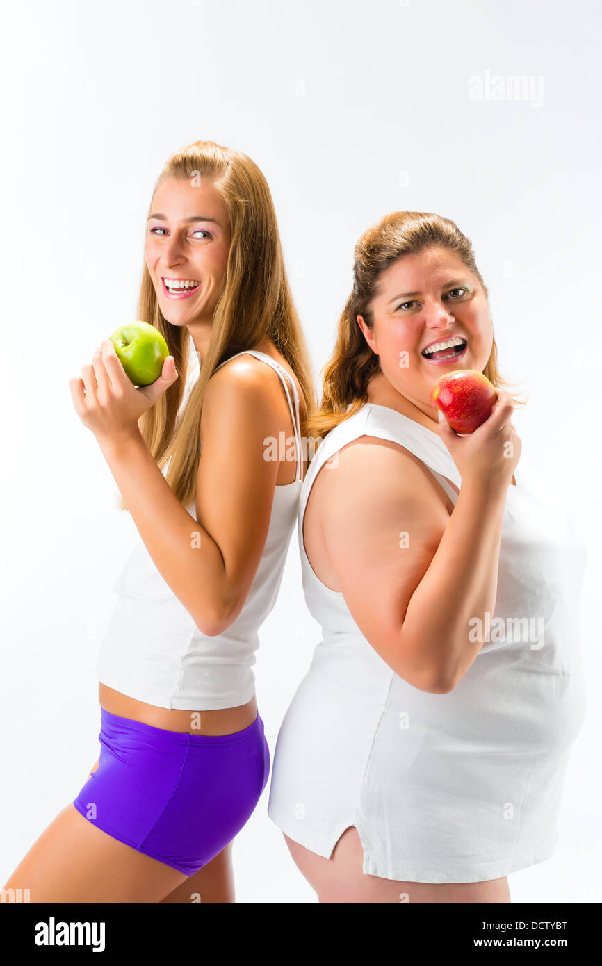 Thin and fat or obese woman standing and holding an apple in hand, studio  shot isolated on white Stock Photo - Alamy