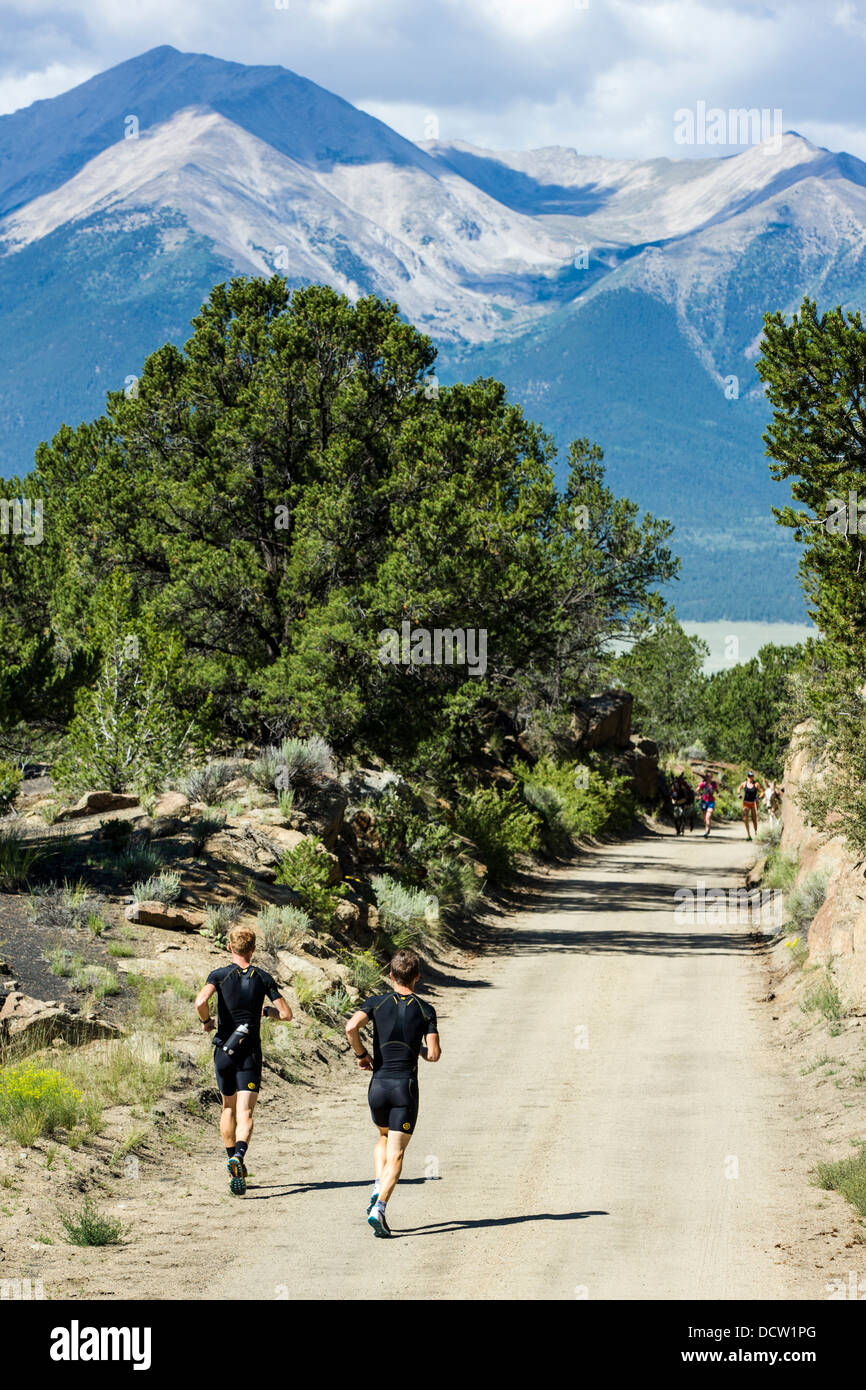 Two trail runners along the Midland Trail, CR304, near Buena Vista, Colorado. Collegiate Peaks beyond. Stock Photo