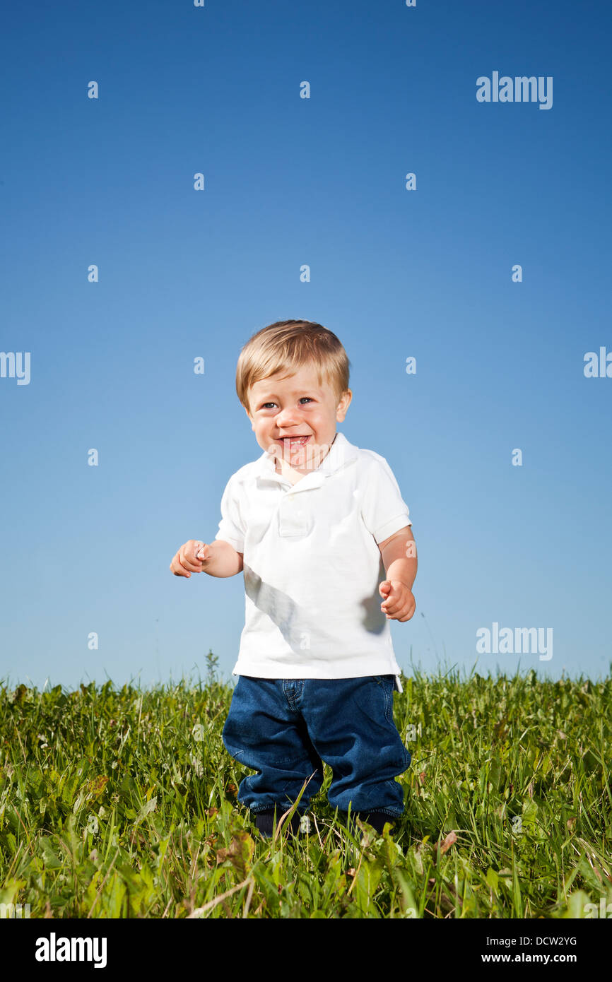 Boy in grass Stock Photo - Alamy