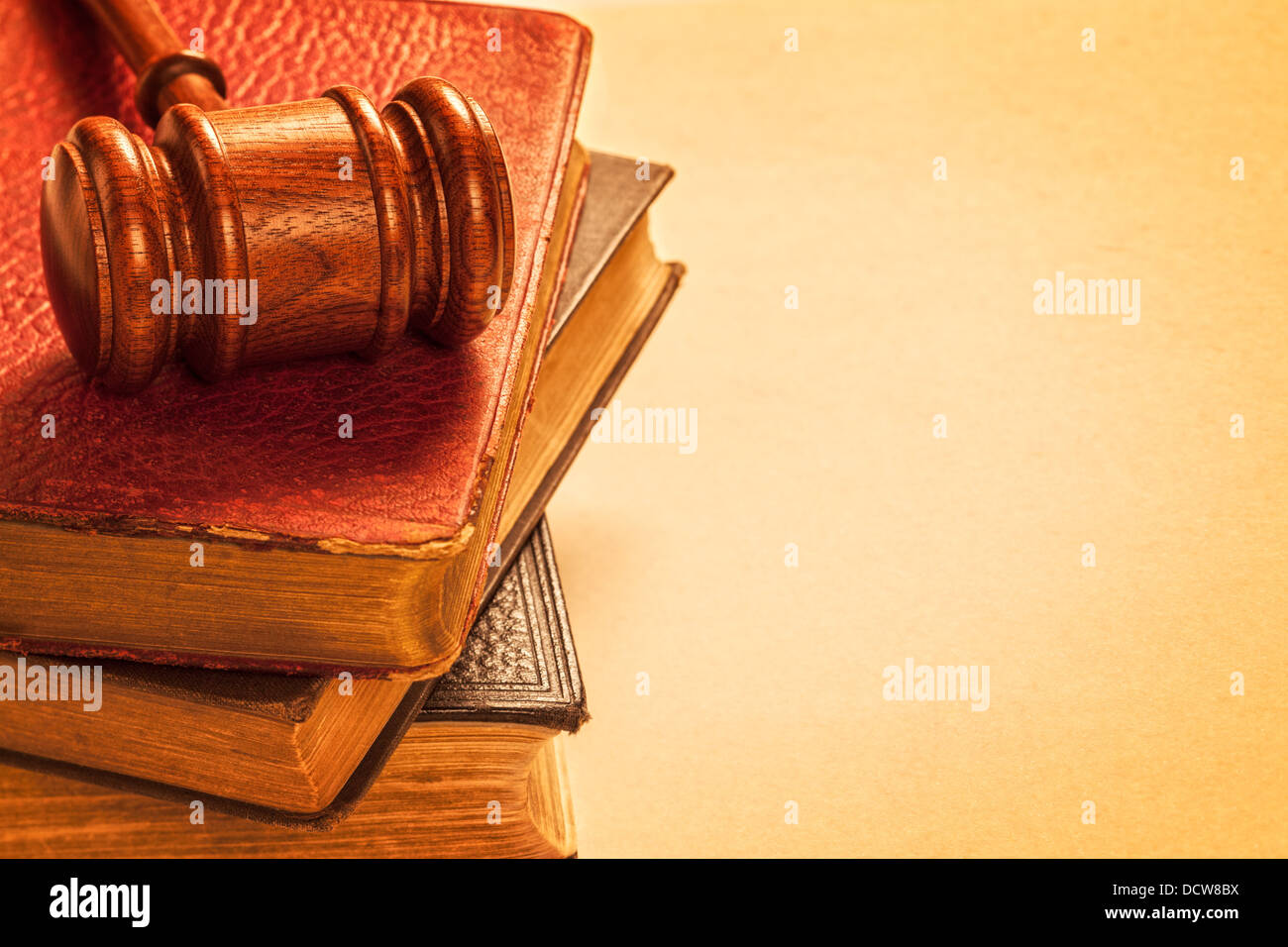 Gavel and Old Books - gavel, a pile of books, and space for text on textured background. Stock Photo