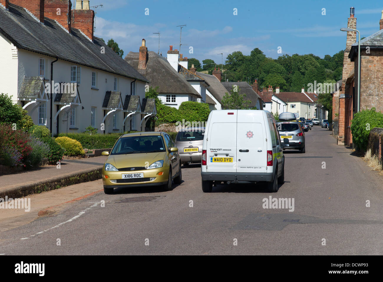 Traffic in village, UK Stock Photo