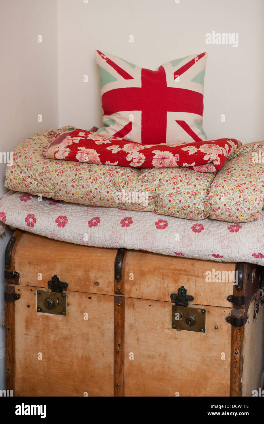 Printed quilts and fabrics on blanket box in Bristol home of British fabric designer Emily Bond Stock Photo