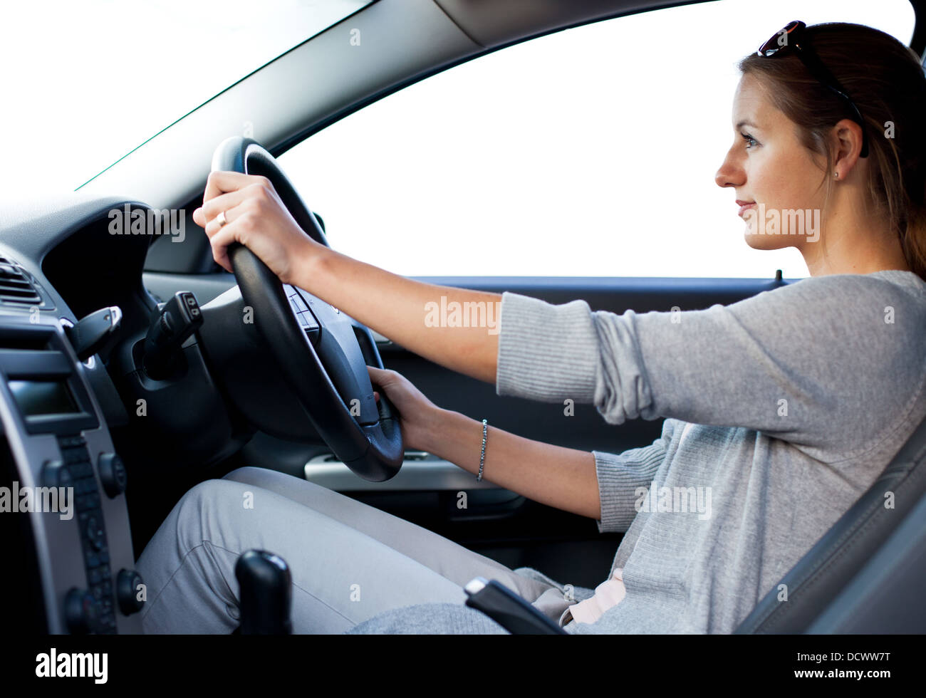 Pretty young woman driving her new car Stock Photo Alamy