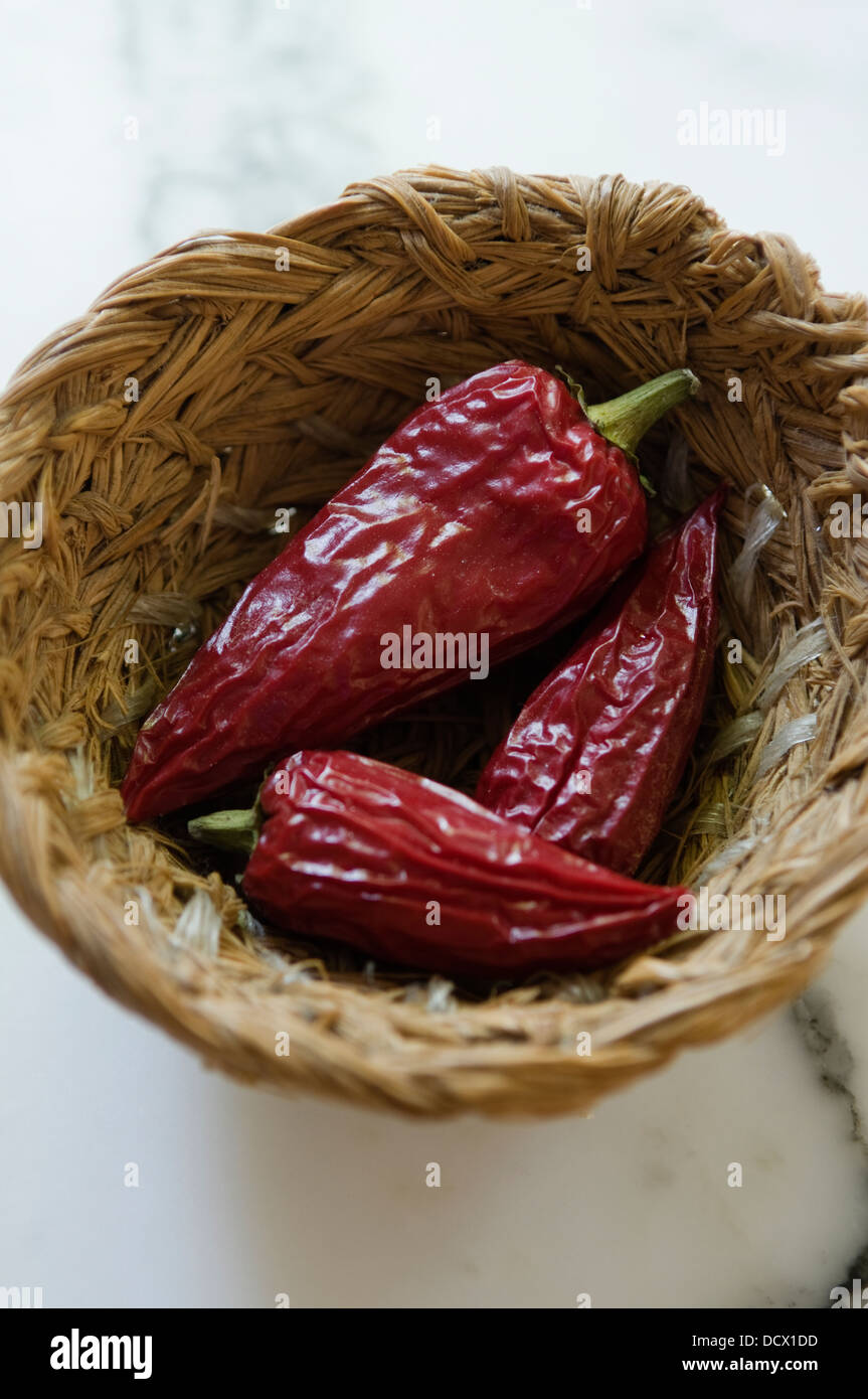 Red chilli peppers in a woven basket Stock Photo