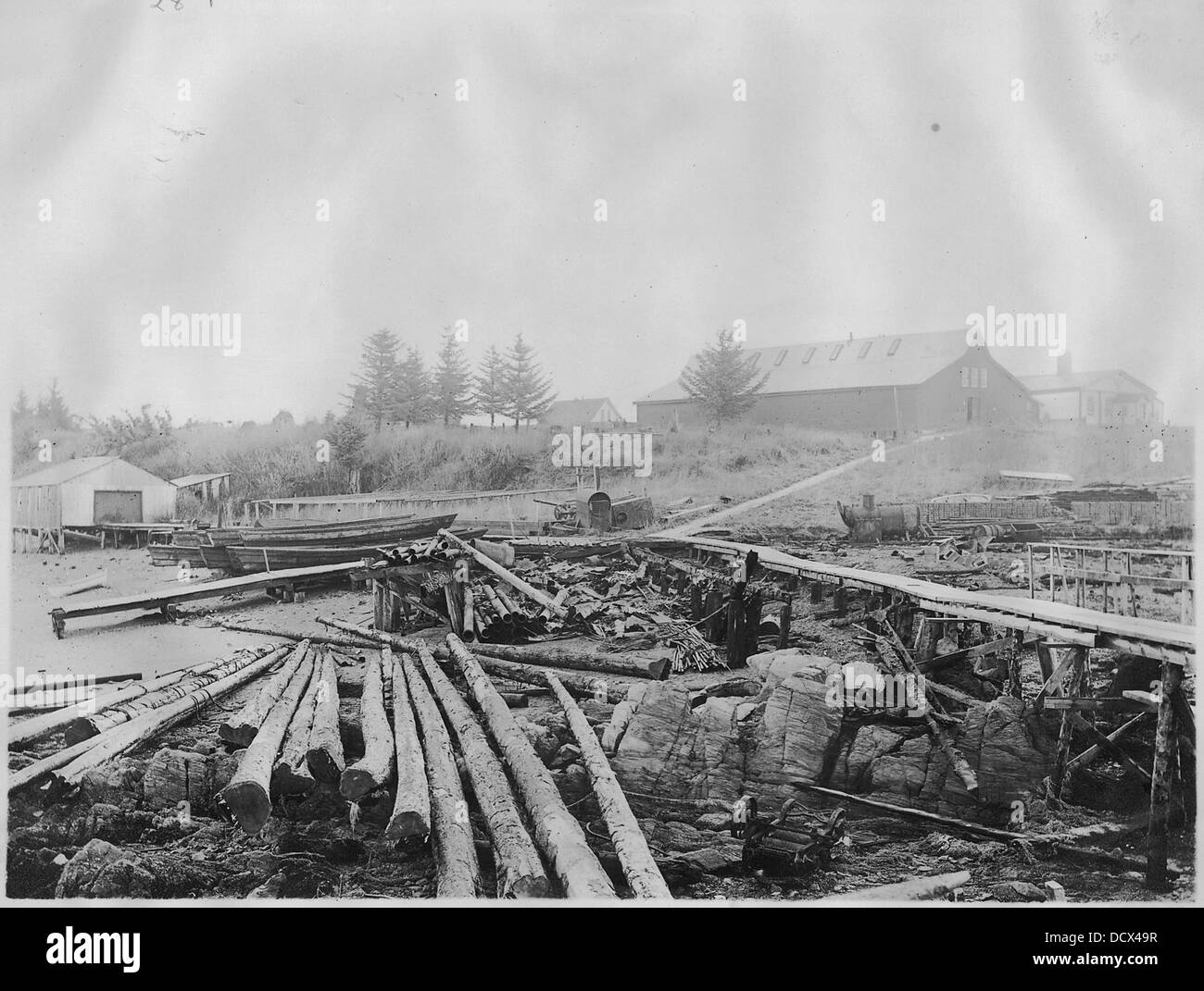 Foreground, debris on beach, Metlakahtla, Alaska. Background, on right, left to right, Duncan's general store... - - 297398 Stock Photo