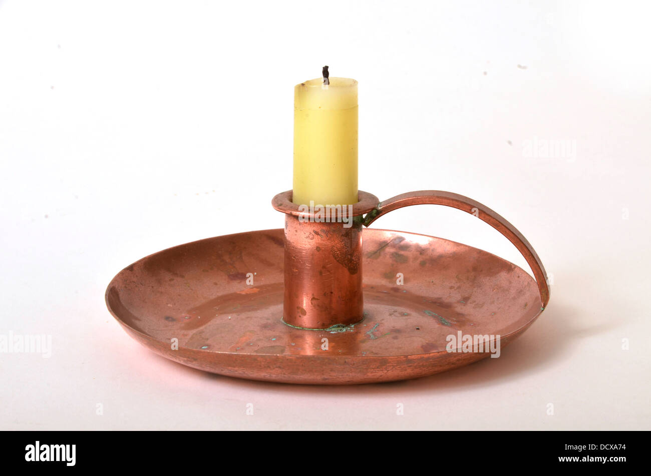 Old copper candlestick and candle Stock Photo