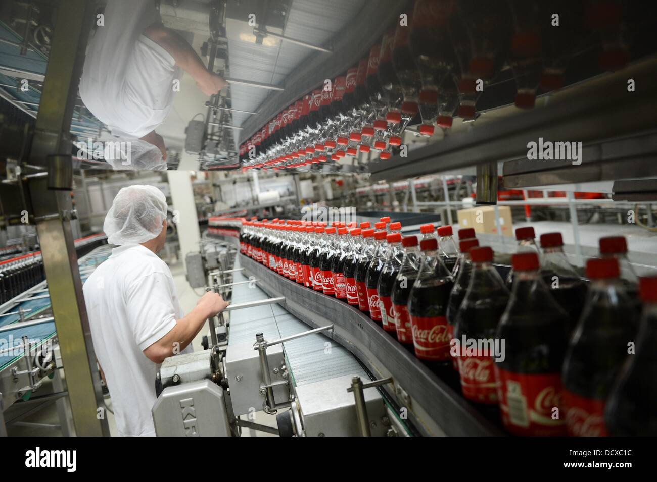 An employee is pictured next to the production line in the bottling