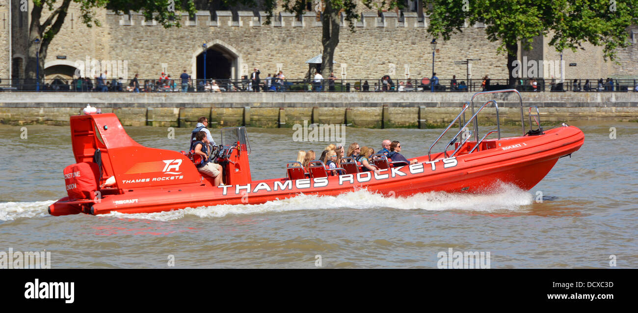 Passengers and tour guide aboard 'Thames Rockets' high speed sightseeing speedboat tour passing the Tower of London Stock Photo