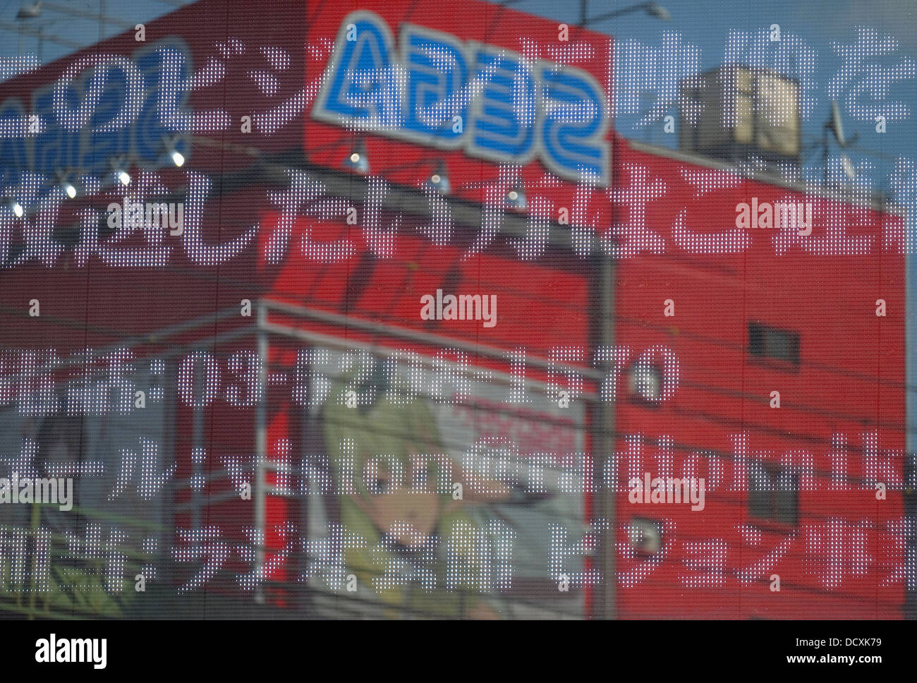 Electronic message board and Sega building reflection in Akihabara Stock Photo