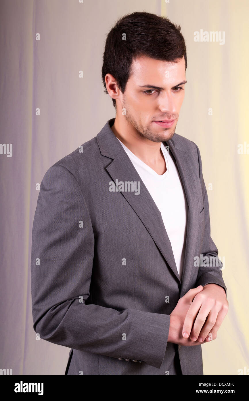 View of a young man standing against a white background Stock Photo - Alamy