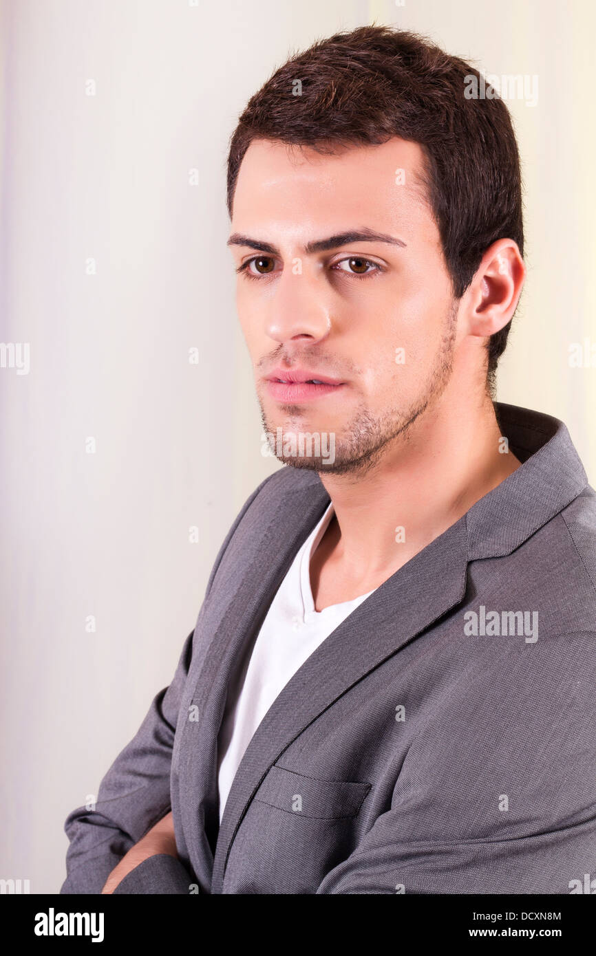 View of a young man standing against a white background Stock Photo - Alamy