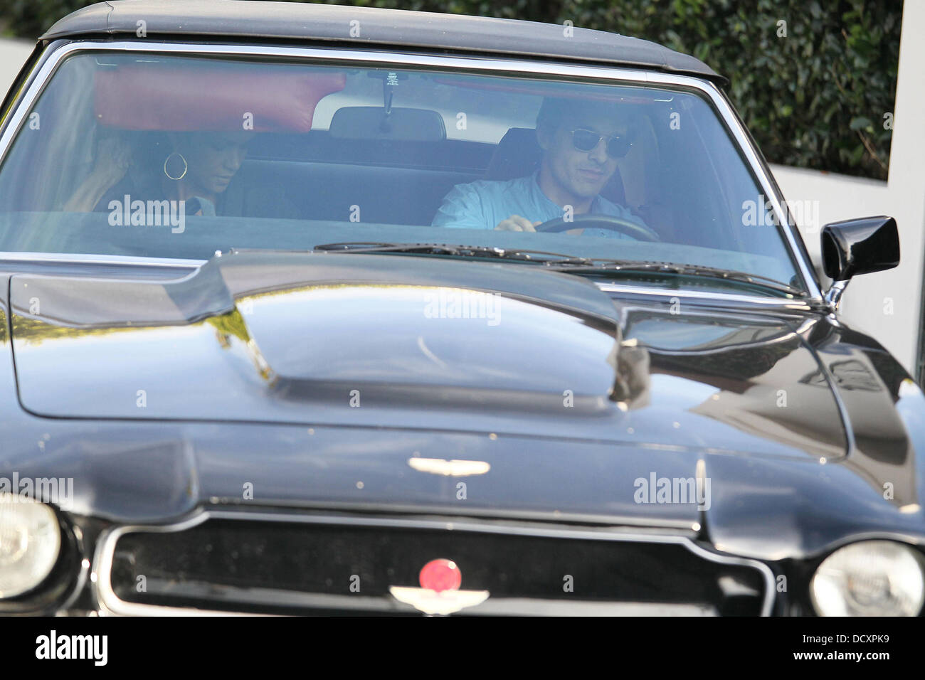 Halle Berry leaves with Olivier Martinez at the wheel of a black Aston Martin V8 Vantage Volante after having lunch at Ciecconi's in Beverly Hills Los Angeles, California - 29.12.11 Stock Photo