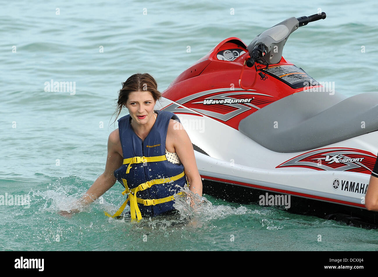 Mischa Barton dressed to impress for an outing on Miami Beach, slapping on a slick of red lipstick while riding a Jet Ski. The actress wore a retro polka-dot bikini and a pair of black high-waisted shorts, while she was also heavily loaded with silver costume jewellery. But the star had obviously forgotten to complete her beauty regime as she hadn't shaved her armpits Miami Beach,  Stock Photo