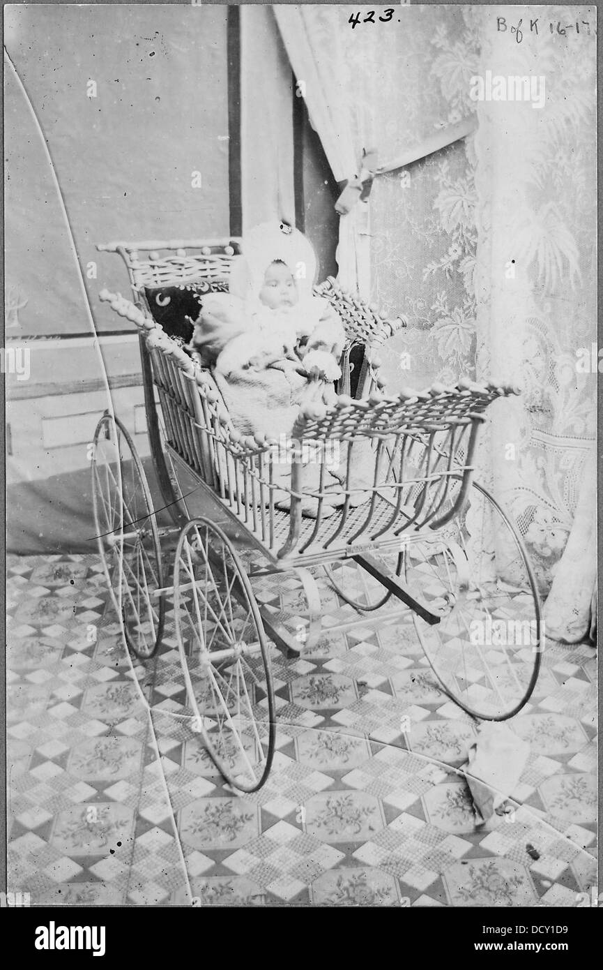 Indian baby in wicker carriage - - 297476 Stock Photo