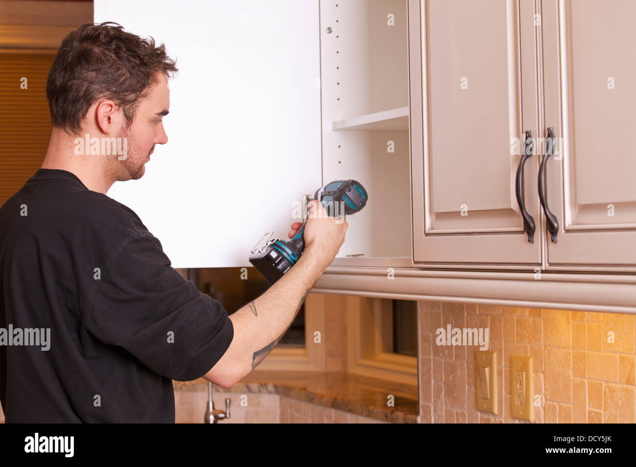 Carpenter Installing New Kitchen Stock Photo Alamy