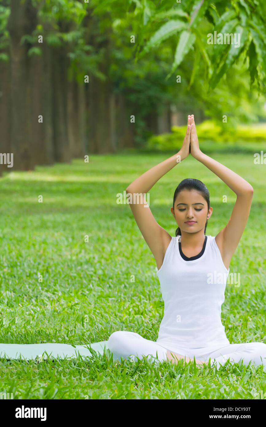Young woman doing yoga with hands in prayer position Stock Photo - Alamy