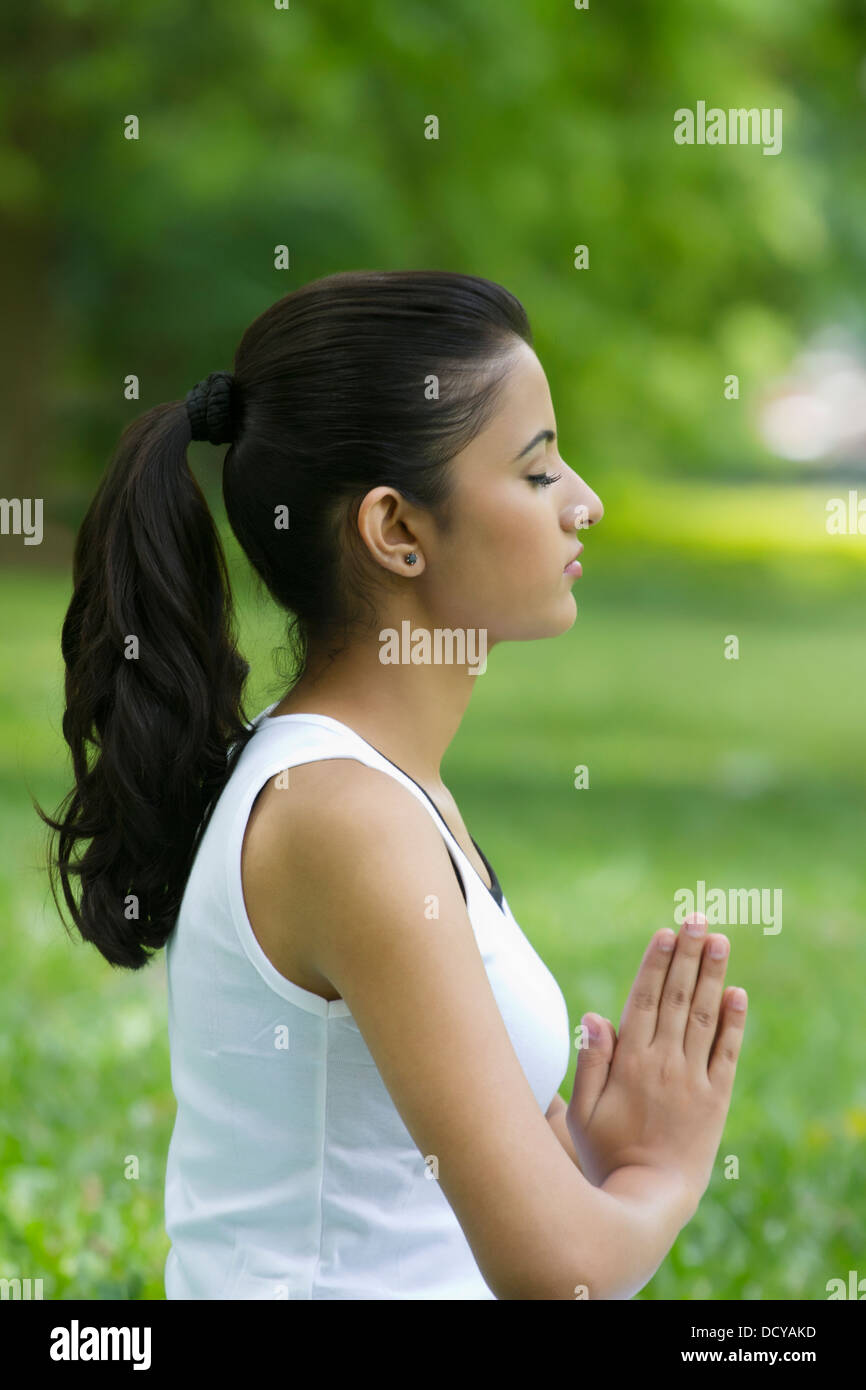 Young woman with hands in prayer position Stock Photo - Alamy