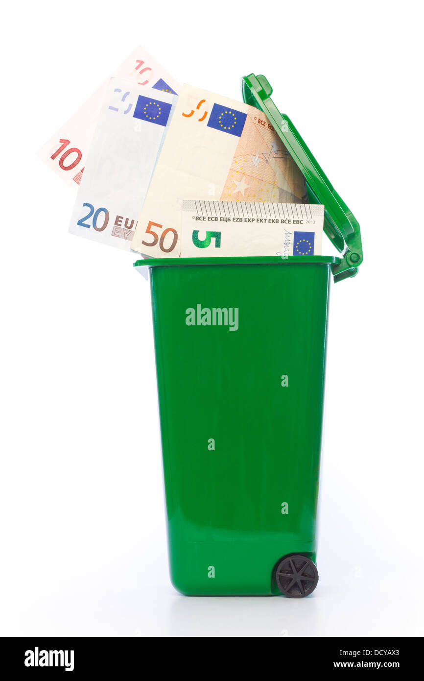 Euro banknotes in green wheelie bin against white background Stock Photo