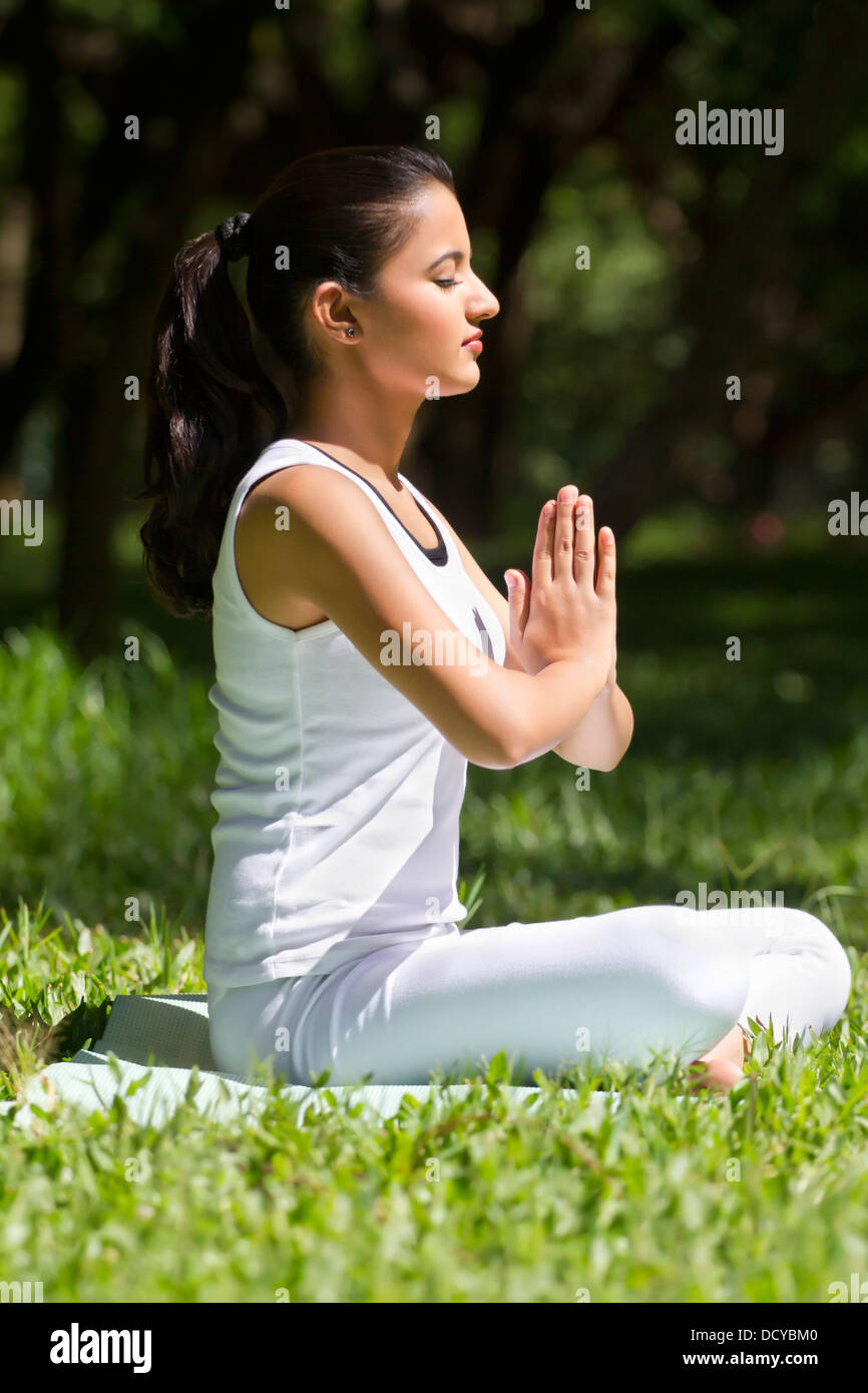 Young woman with hands in prayer position Stock Photo - Alamy