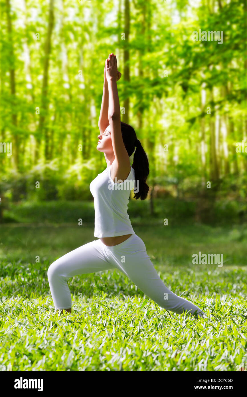 Young woman doing yoga with hands outstretched Stock Photo - Alamy