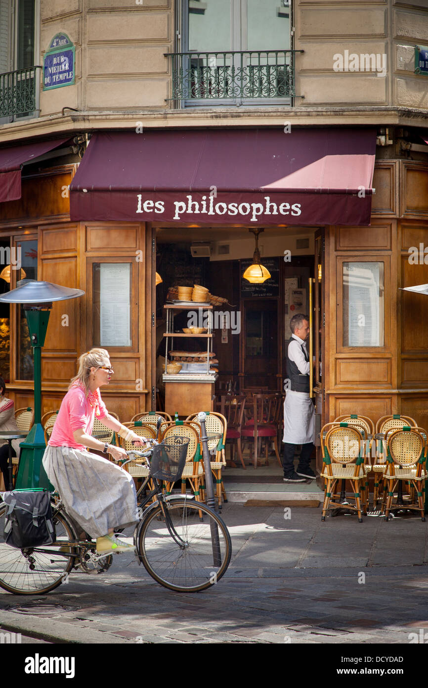 Woman riding bike in the Marais District, Paris, France Stock Photo