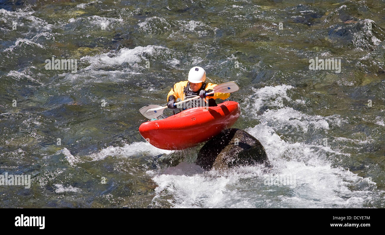 A senior citizen kayaker on the Upper McKenzie River in the central Oregon Cascade Mountains. Stock Photo