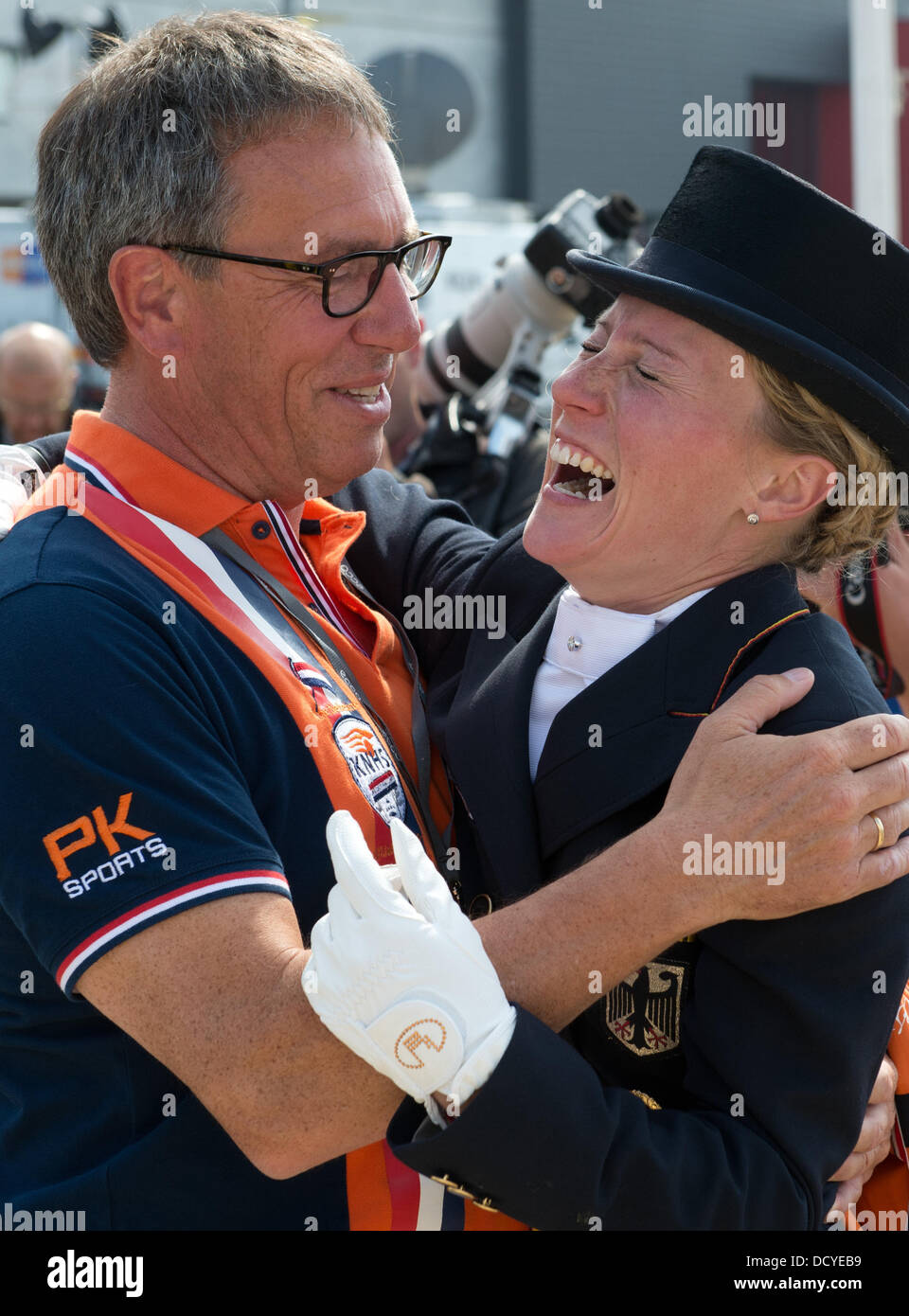 Herning, Denmark, Germany. 22nd Aug, 2013. German dressage rider Helen Langehanenberg hugs Dutch dressage coach Wim Ernes after the team competition of the FEI European Championships in Herning, Denmark, Germany, 22 August 2013. The German team finished first. Photo: Jochen Luebke/dpa/Alamy Live News Stock Photo